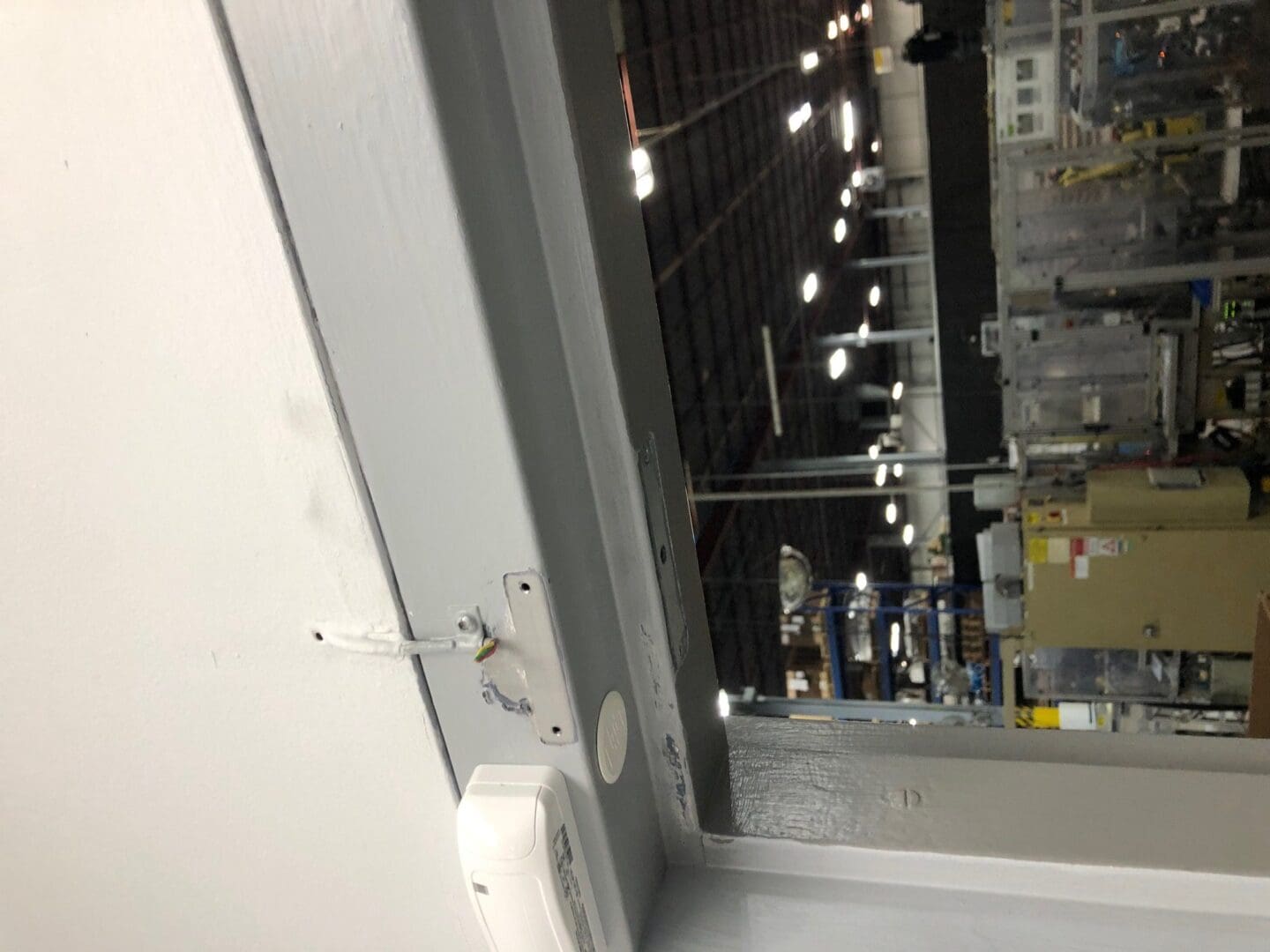 A ceiling fan hanging from the side of a building.