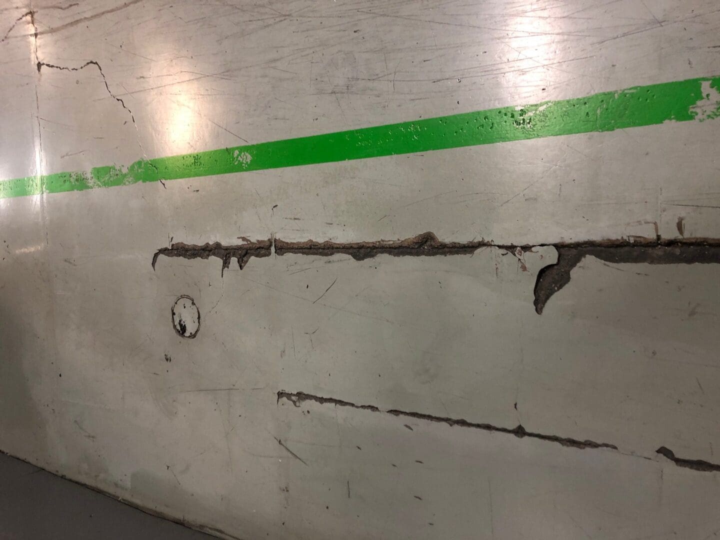 A green line is on the floor of an office building.