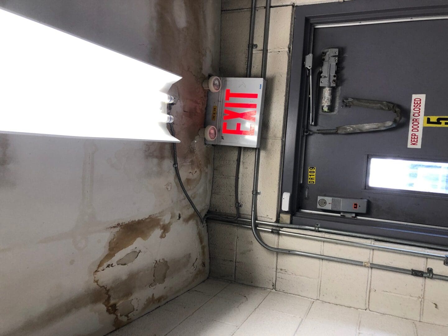 A sign that says exit in front of an entrance.