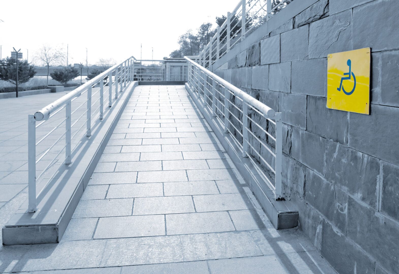 A walkway with a yellow sign on the side.