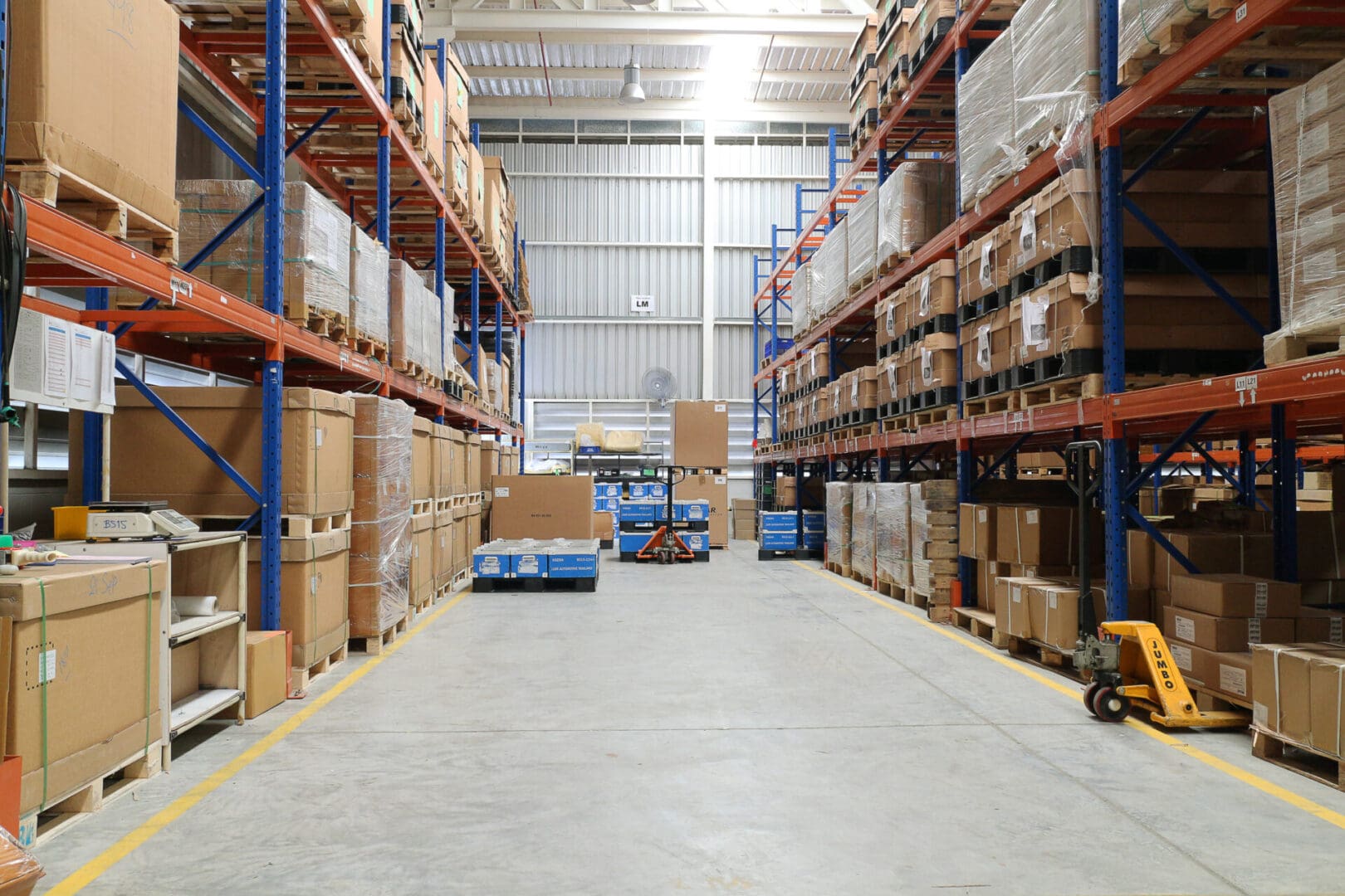 A warehouse filled with lots of boxes and a forklift.