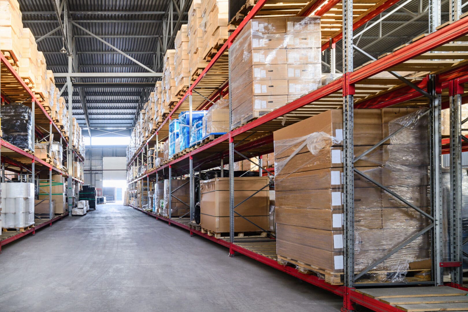 A warehouse with many boxes on the shelves.