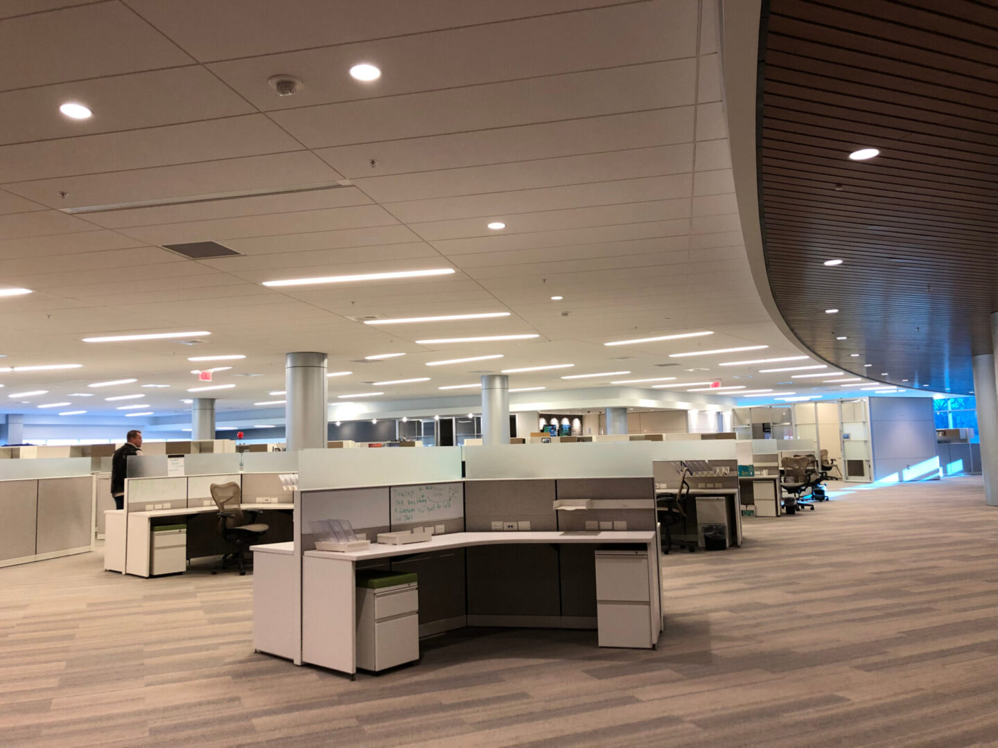 A large open office space with many desks.