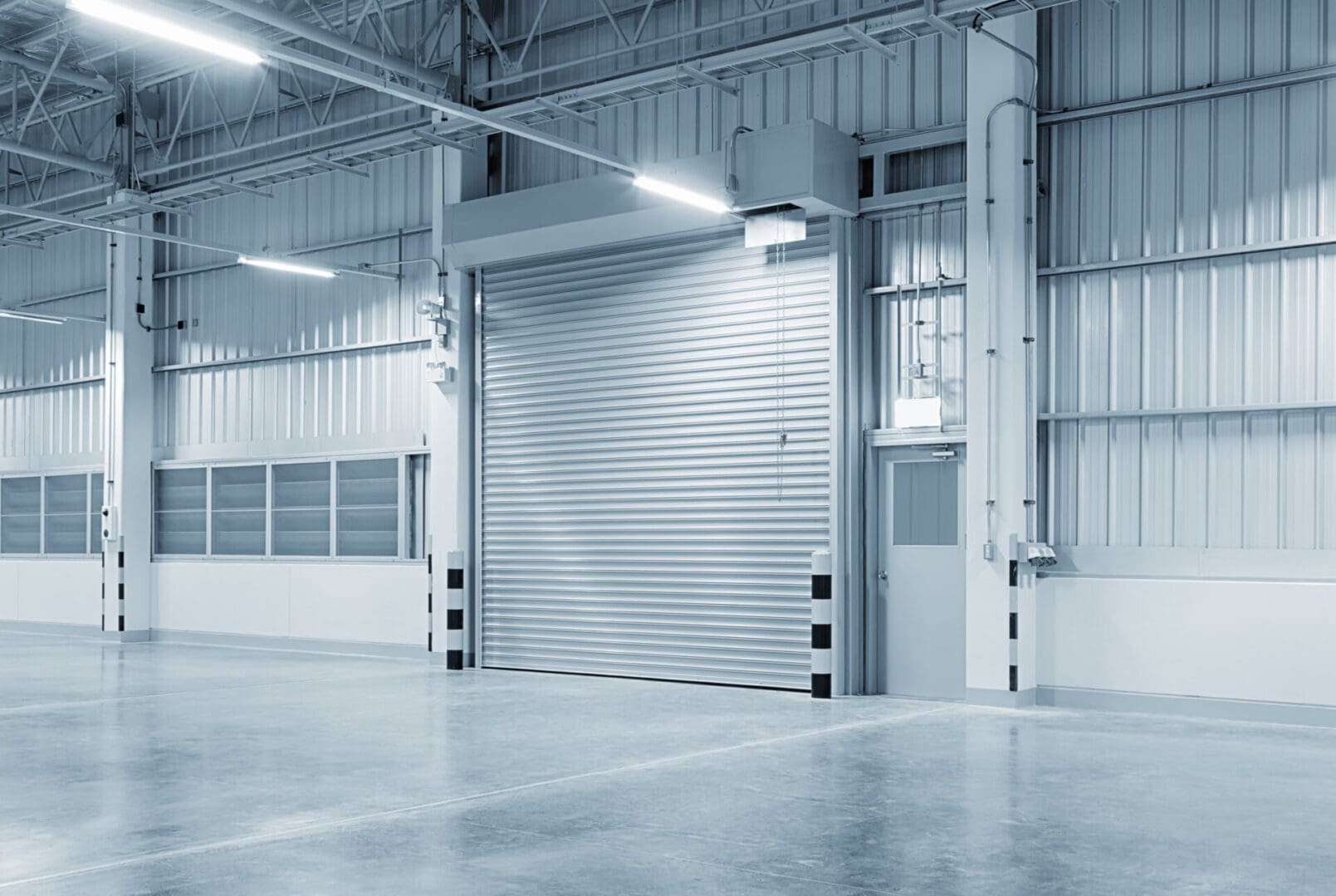 A warehouse with a door open and no people inside.