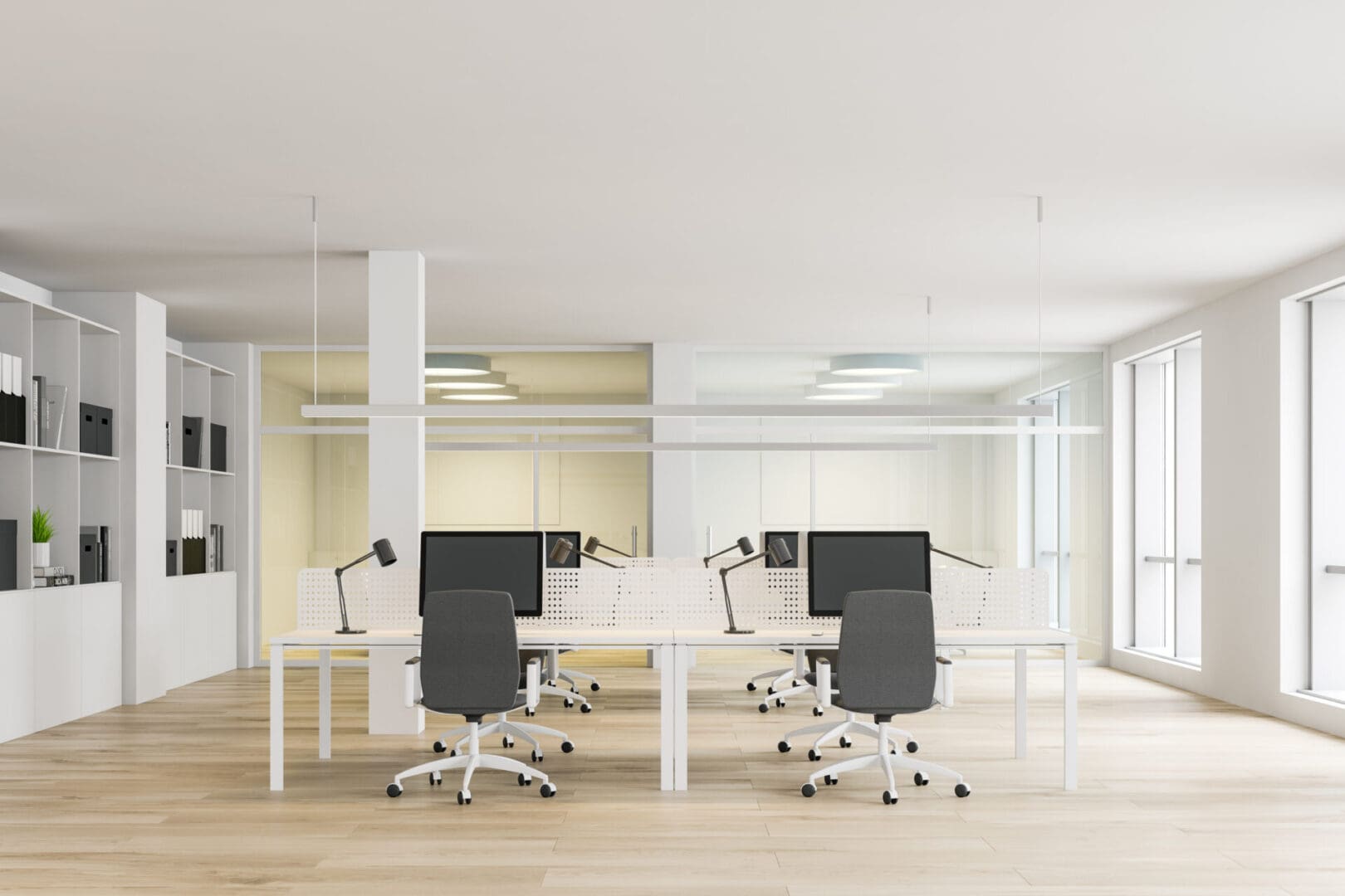 A room with four white tables and two black chairs.