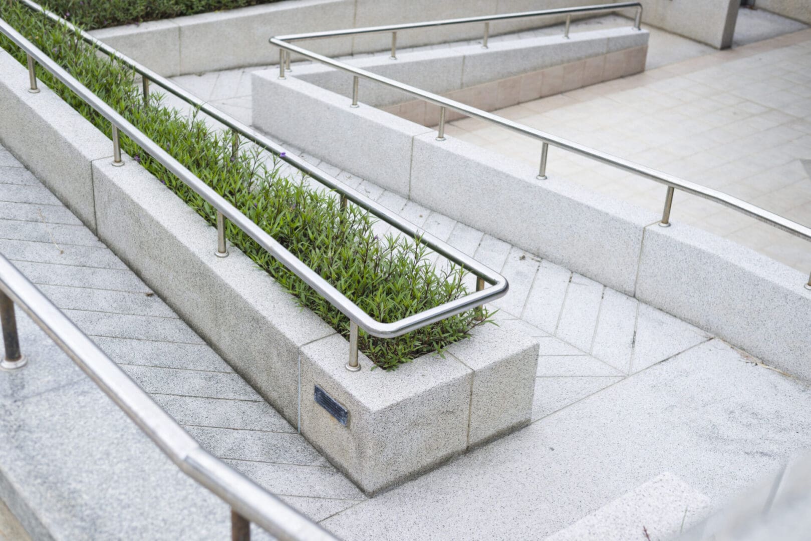 A concrete planter with plants growing in it.