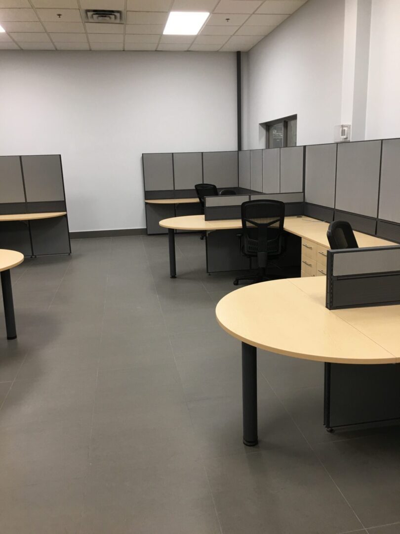 A room with many desks and chairs in it