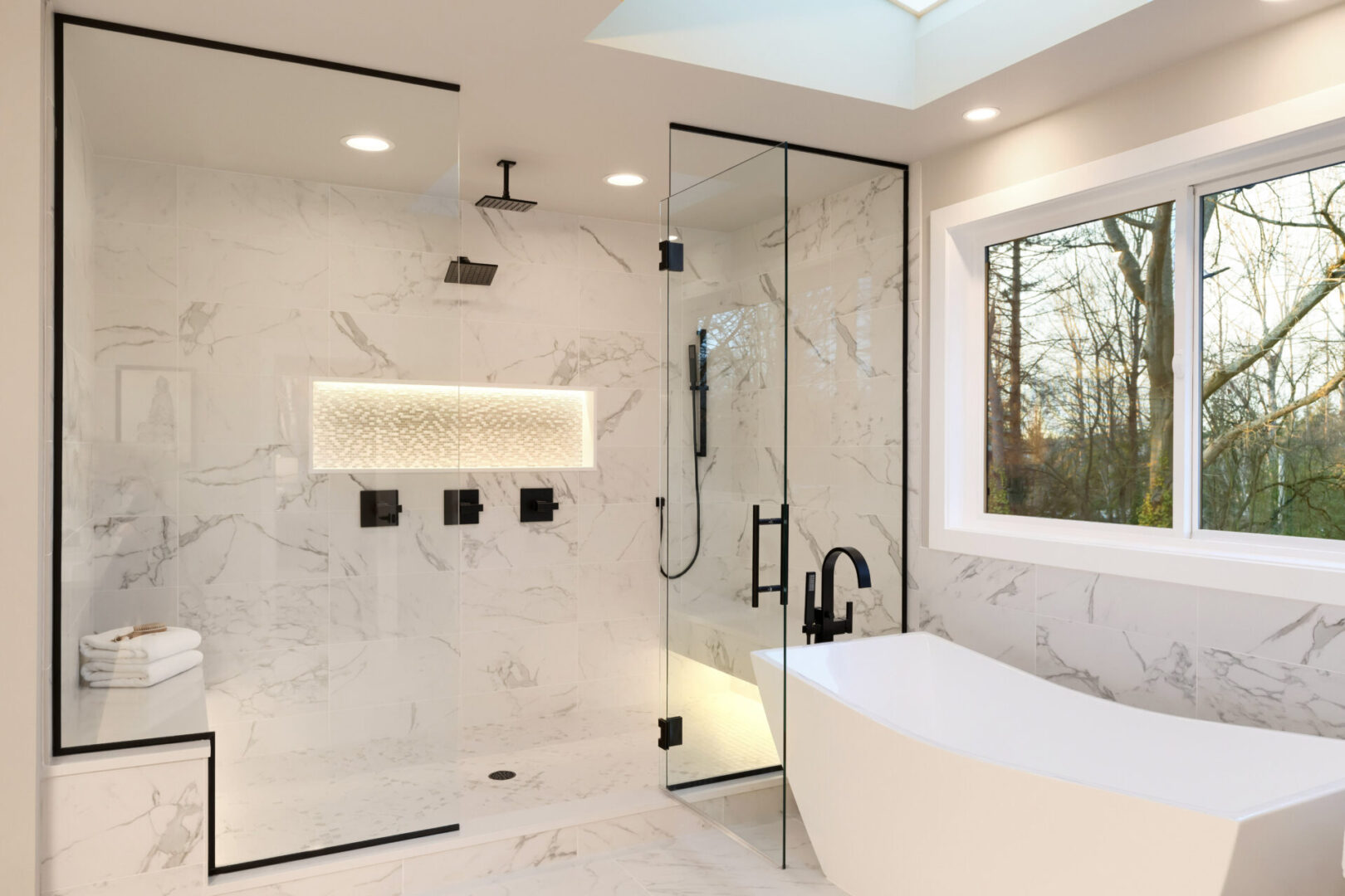 A bathroom with a large walk in shower and a tub.