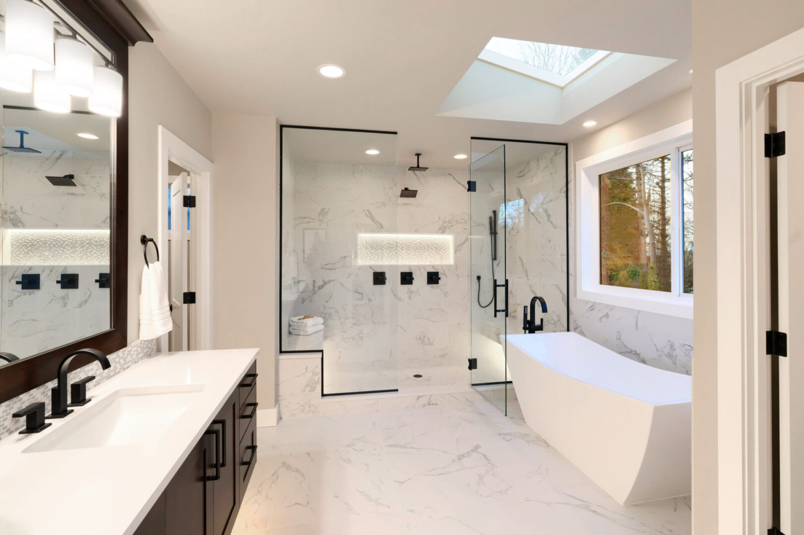 A bathroom with a large walk in shower and a bathtub.
