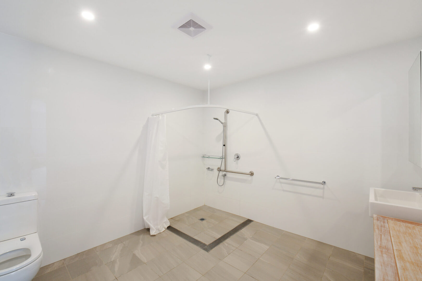 A bathroom with a shower and tiled floor.
