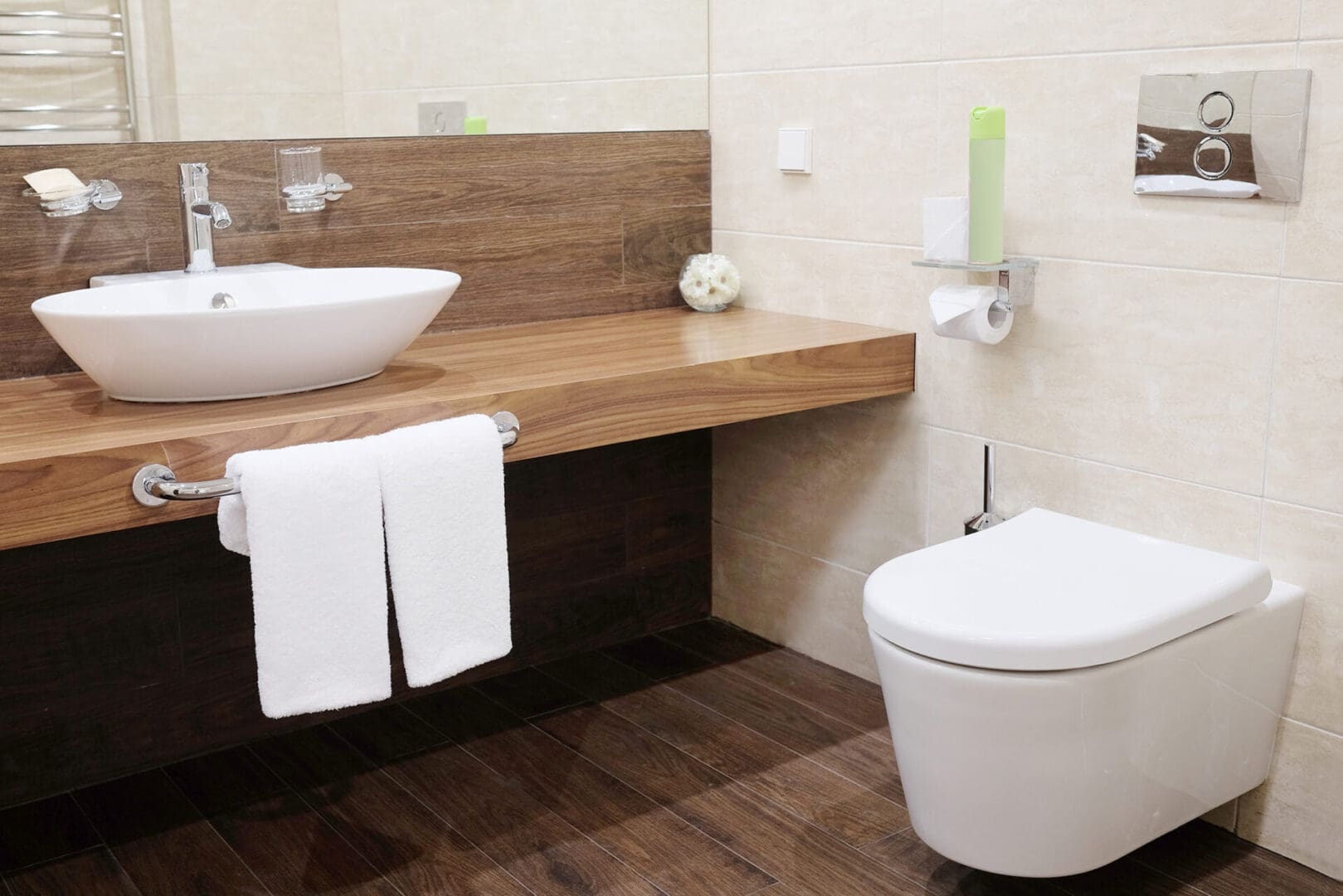 A bathroom with wood floors and white walls.