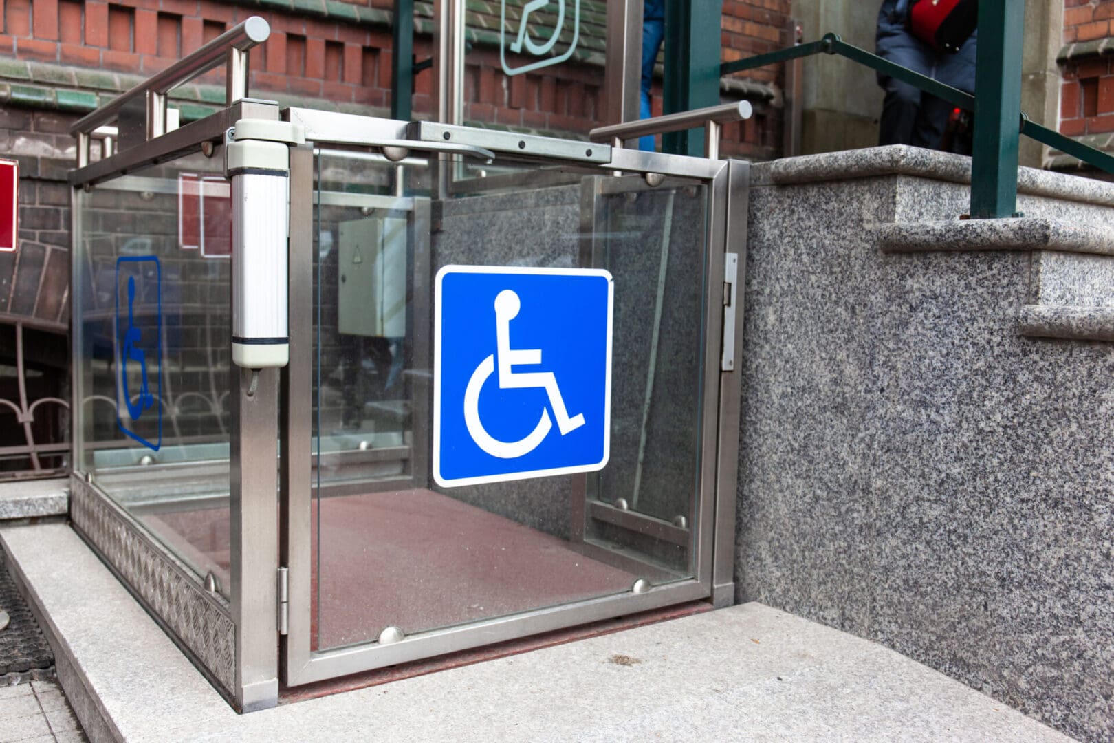 A blue handicap sign on the side of a building.