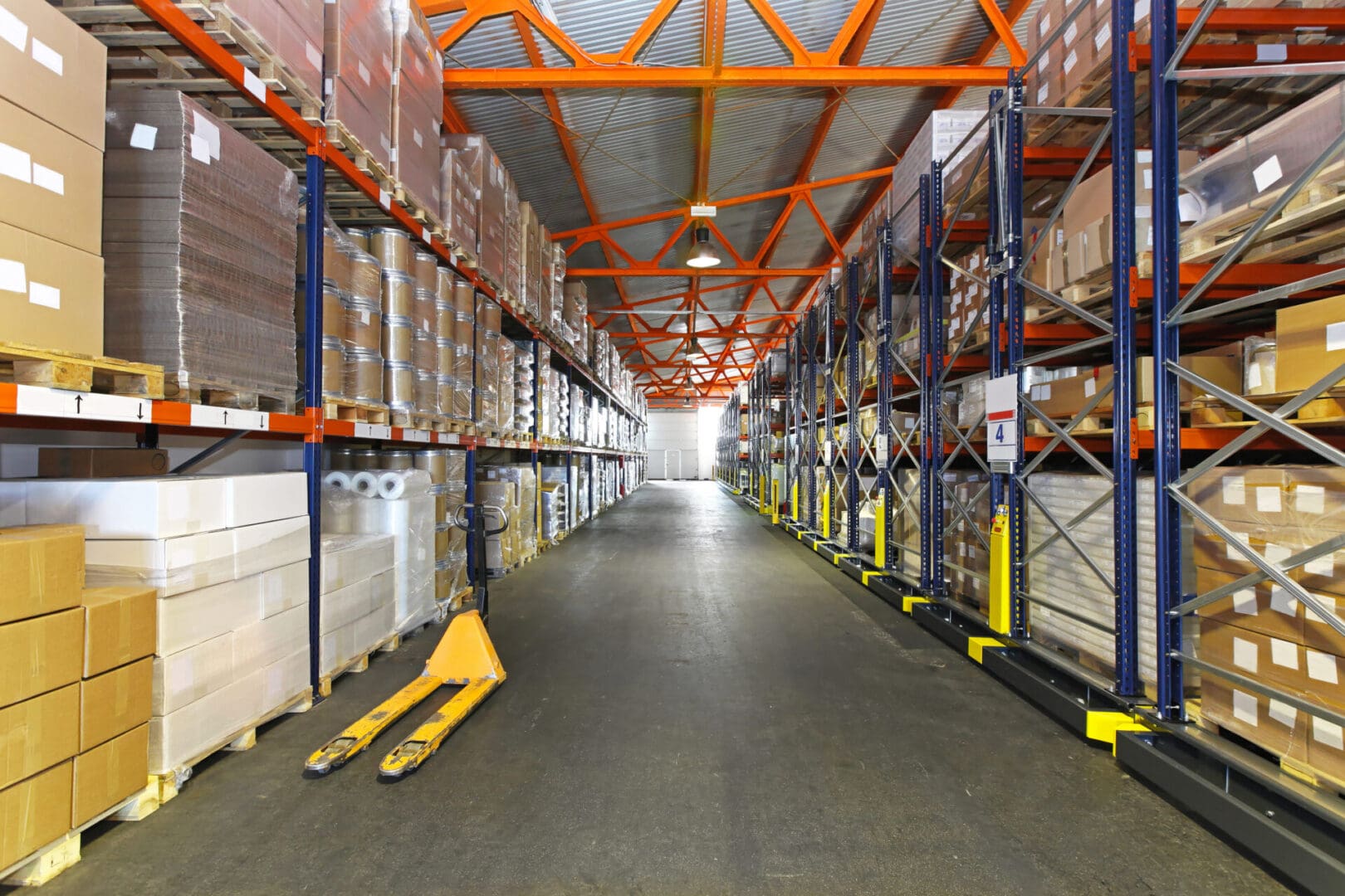 A warehouse with many boxes and pallets of goods.