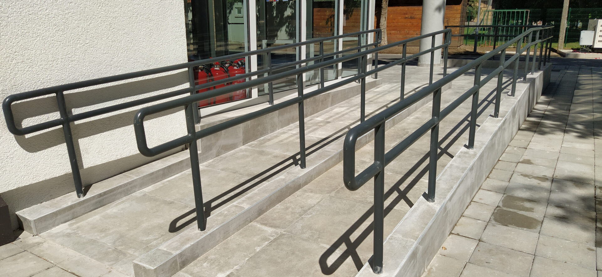A metal railing on the side of steps.