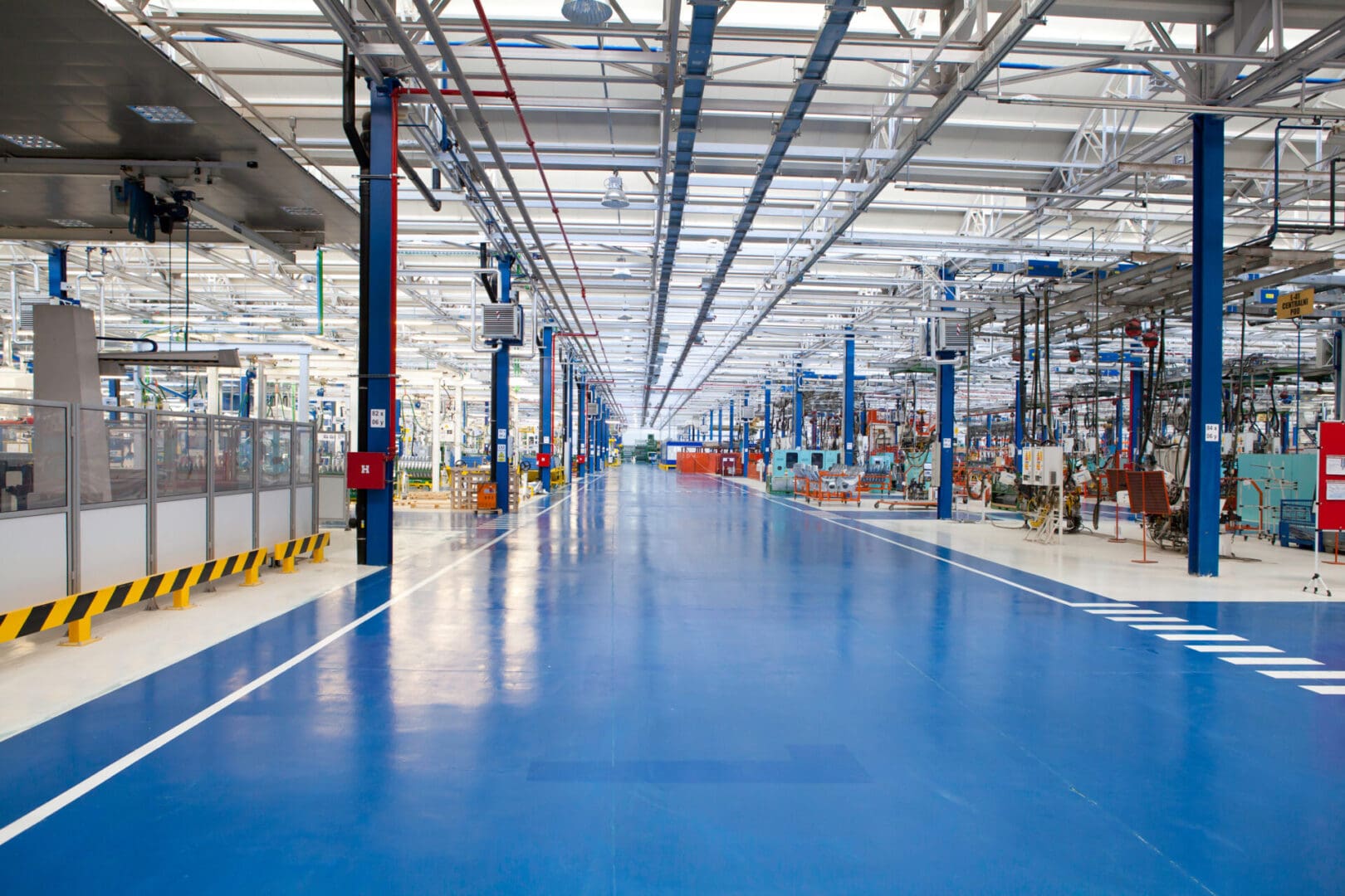 A factory floor with many blue floors and white walls.