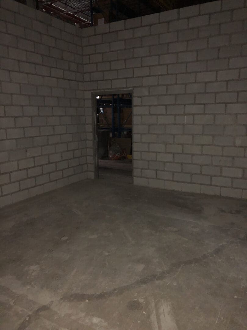 A room with brick walls and concrete floors.