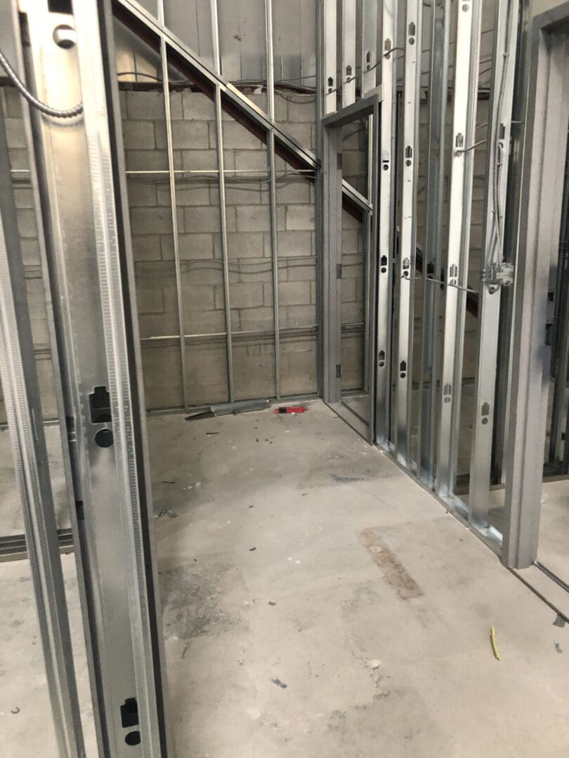 A room with metal framing and stairs in it.