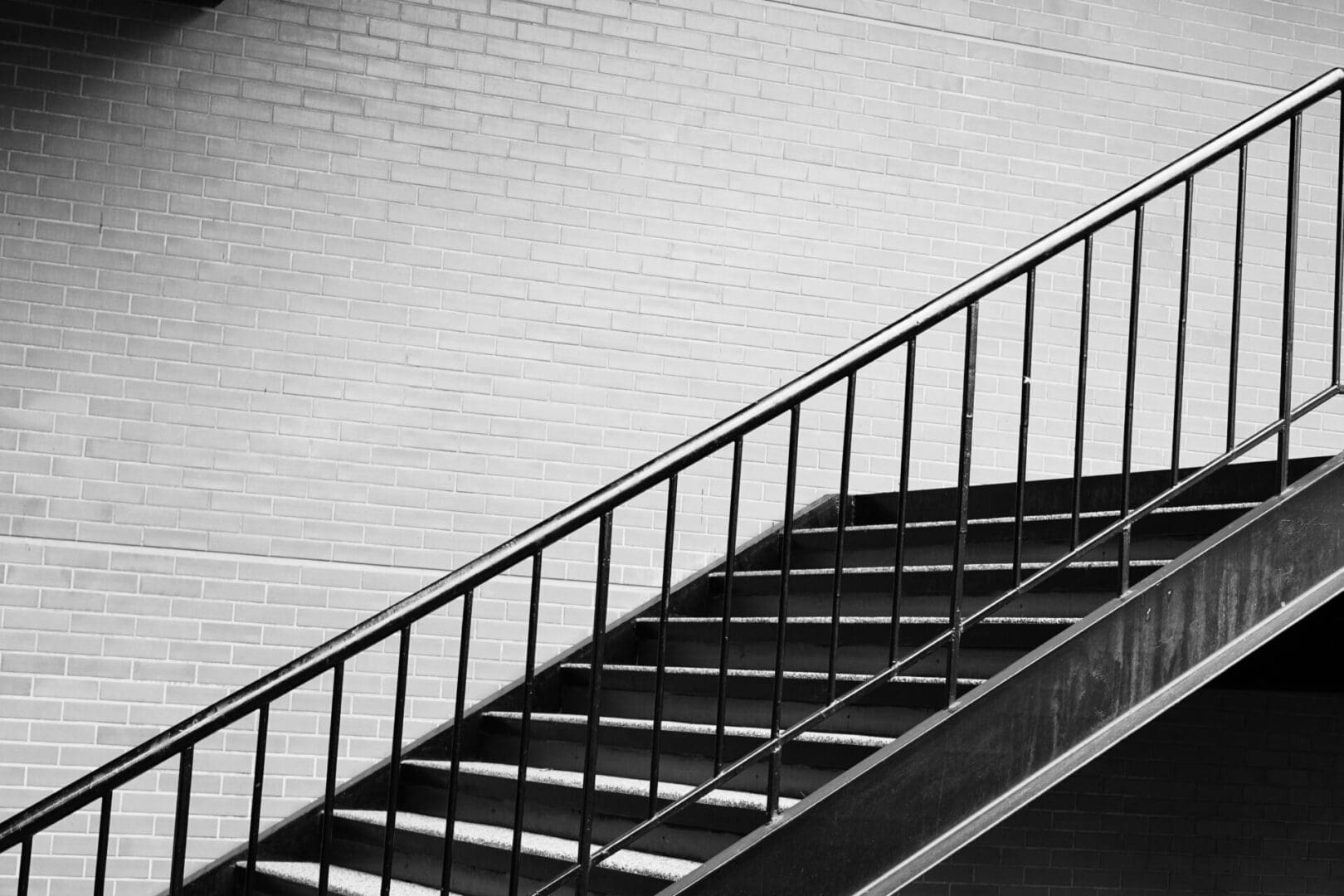 A black and white photo of stairs leading to the top.