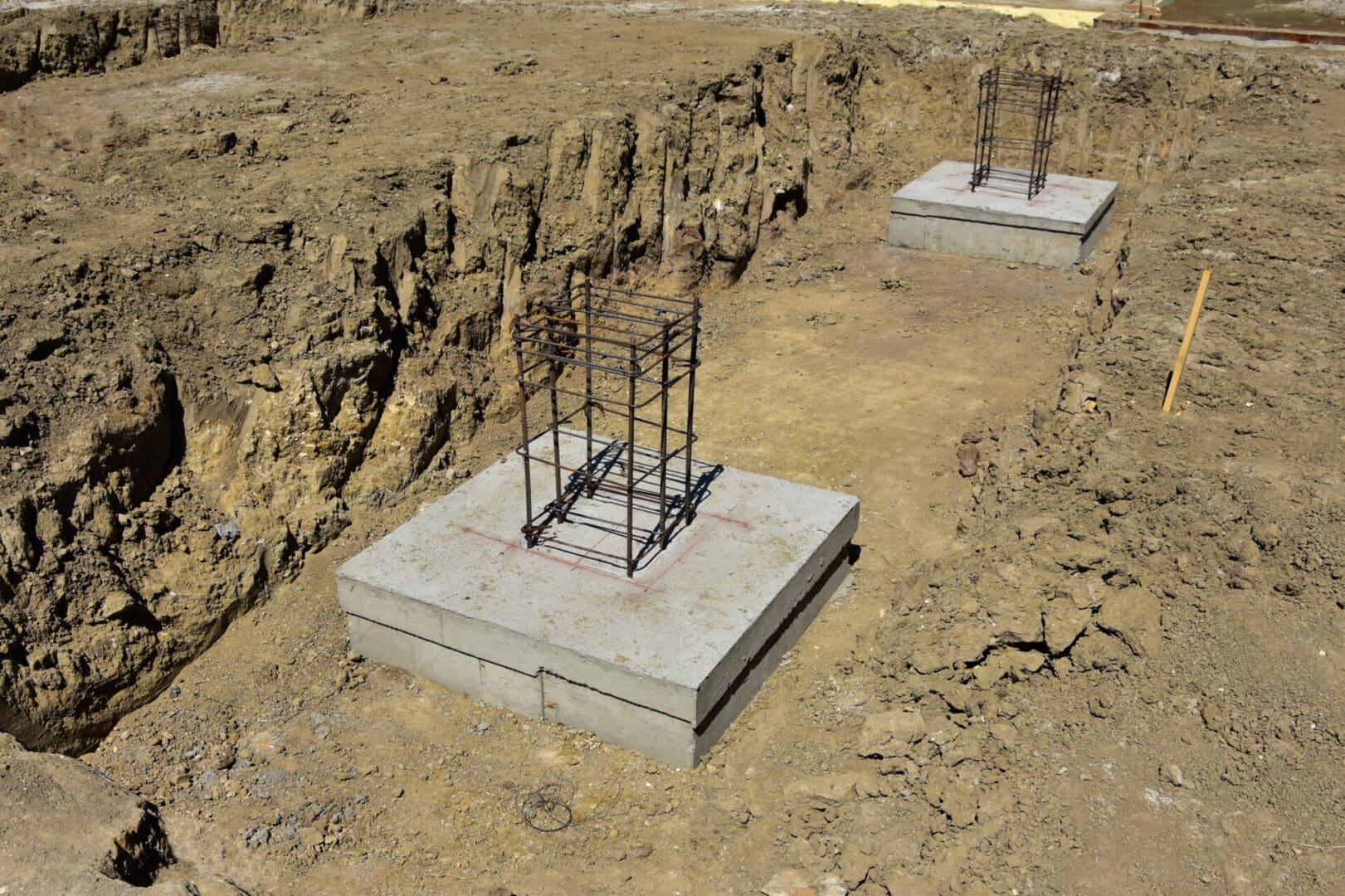 Two concrete blocks with metal posts on them.