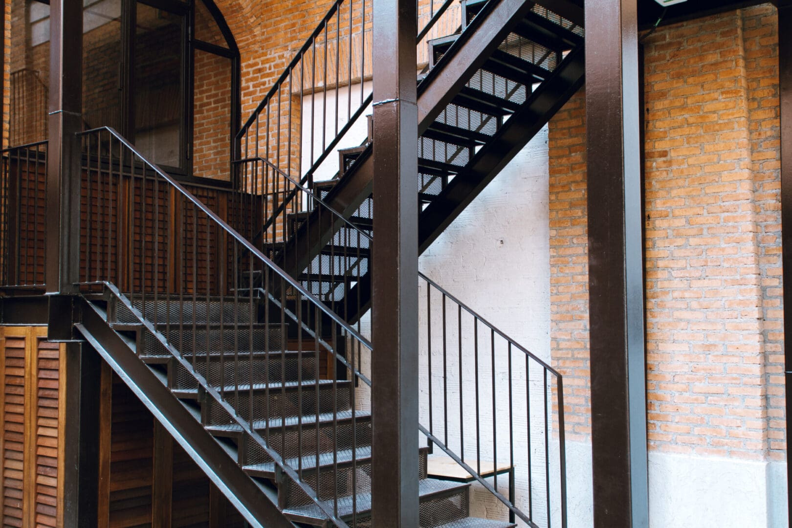 A staircase with metal railing and steps.