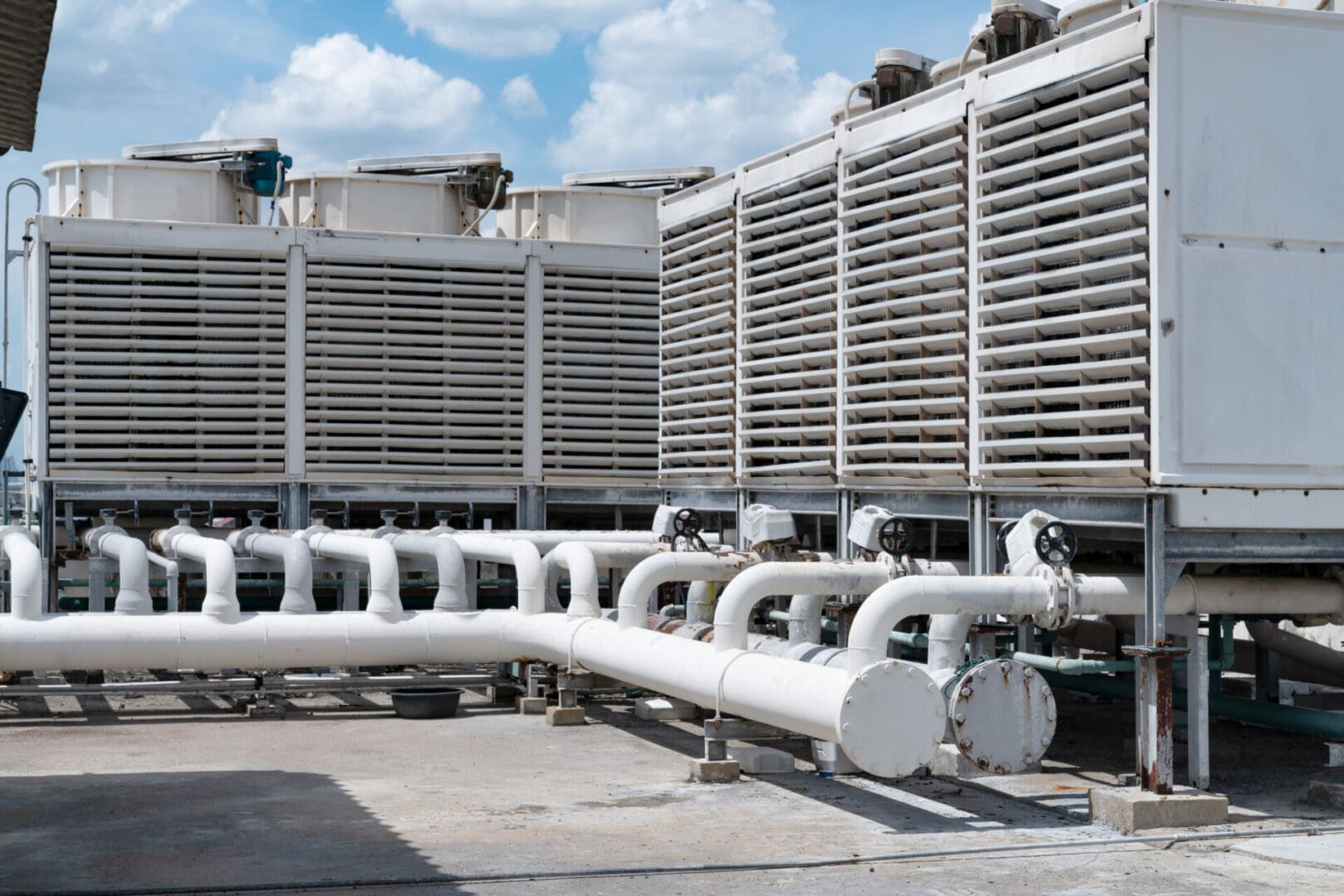 A large cooling tower with pipes connected to it.