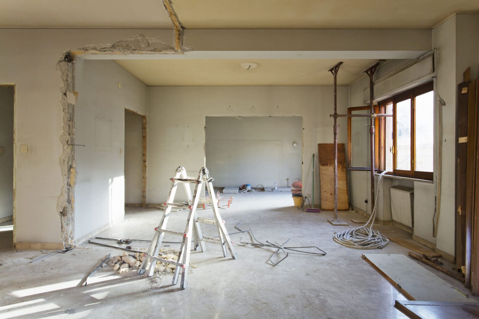 A room being remodeled with ladders and scaffolding.