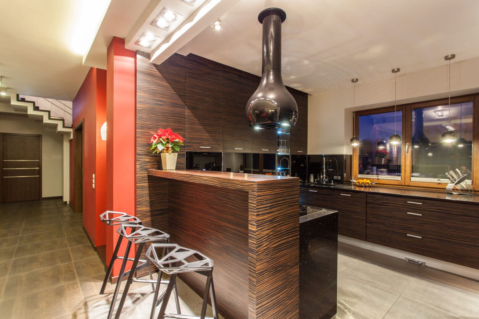 A kitchen with a bar and stools in it