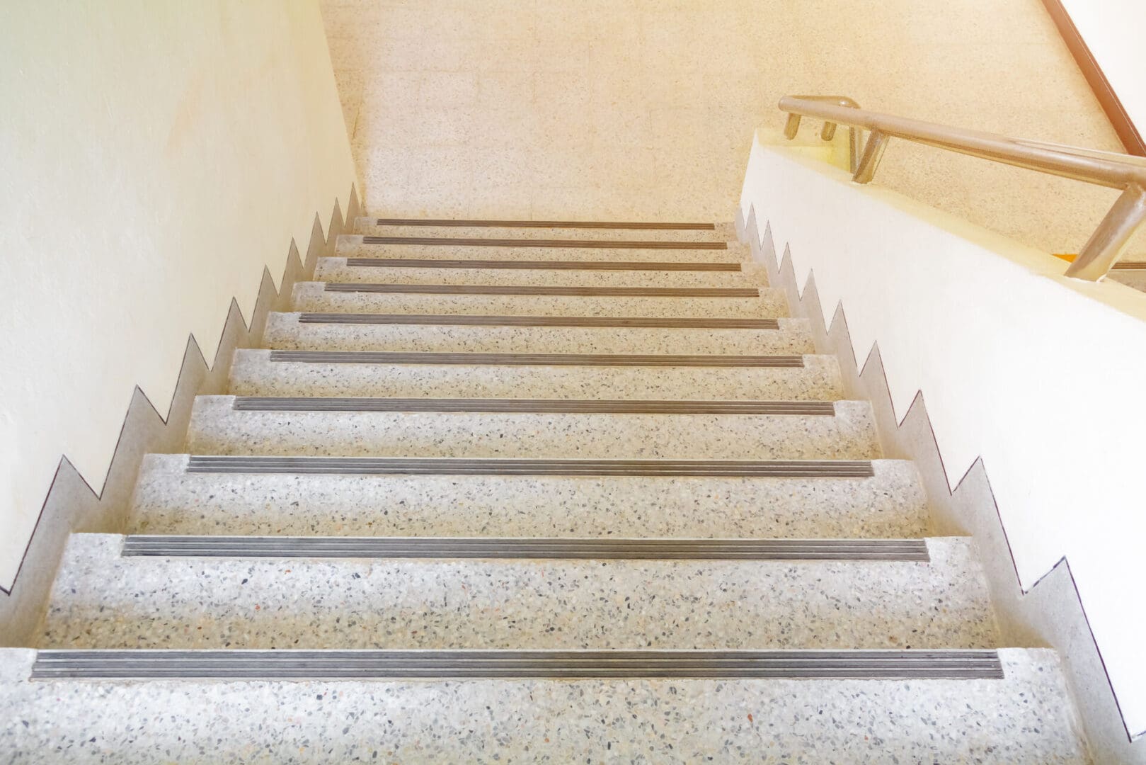 A staircase with white steps and a railing.
