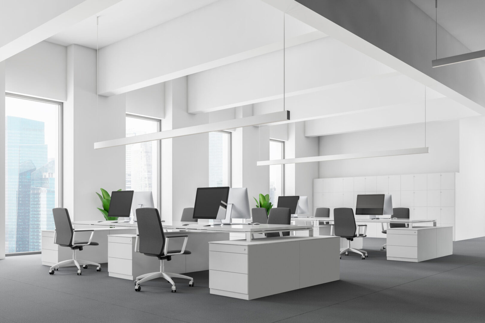 A large open office space with white walls and furniture.