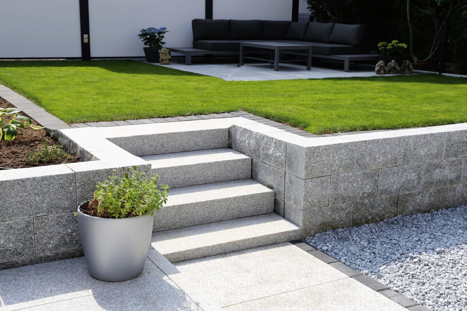 A patio with steps and grass in the middle of it