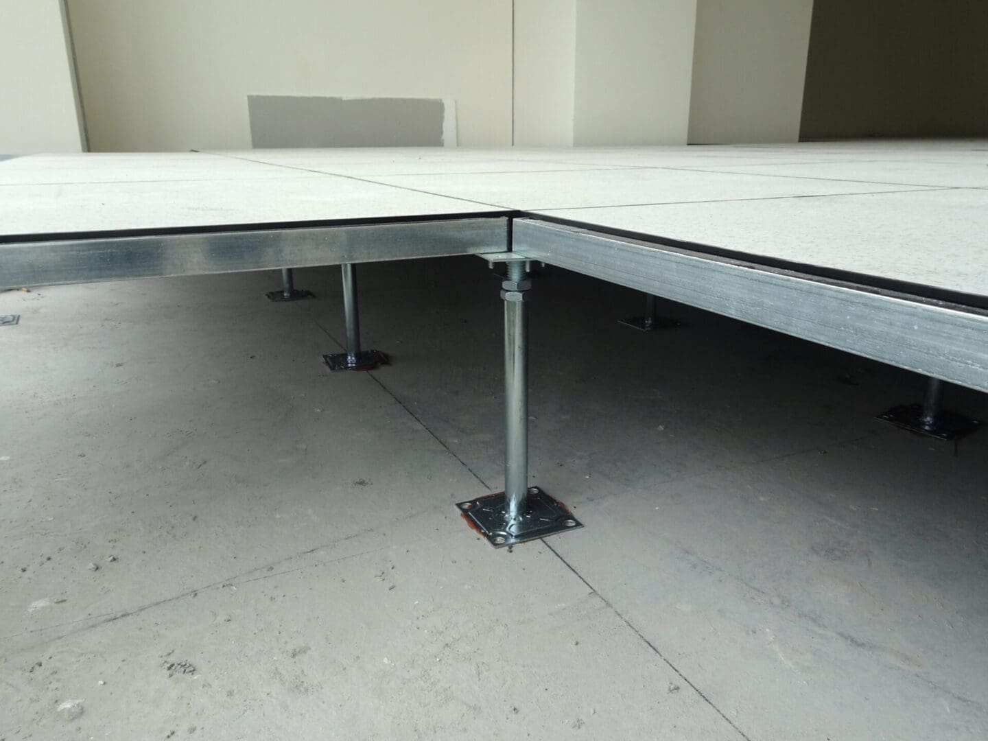 A white tile floor with metal posts and legs.