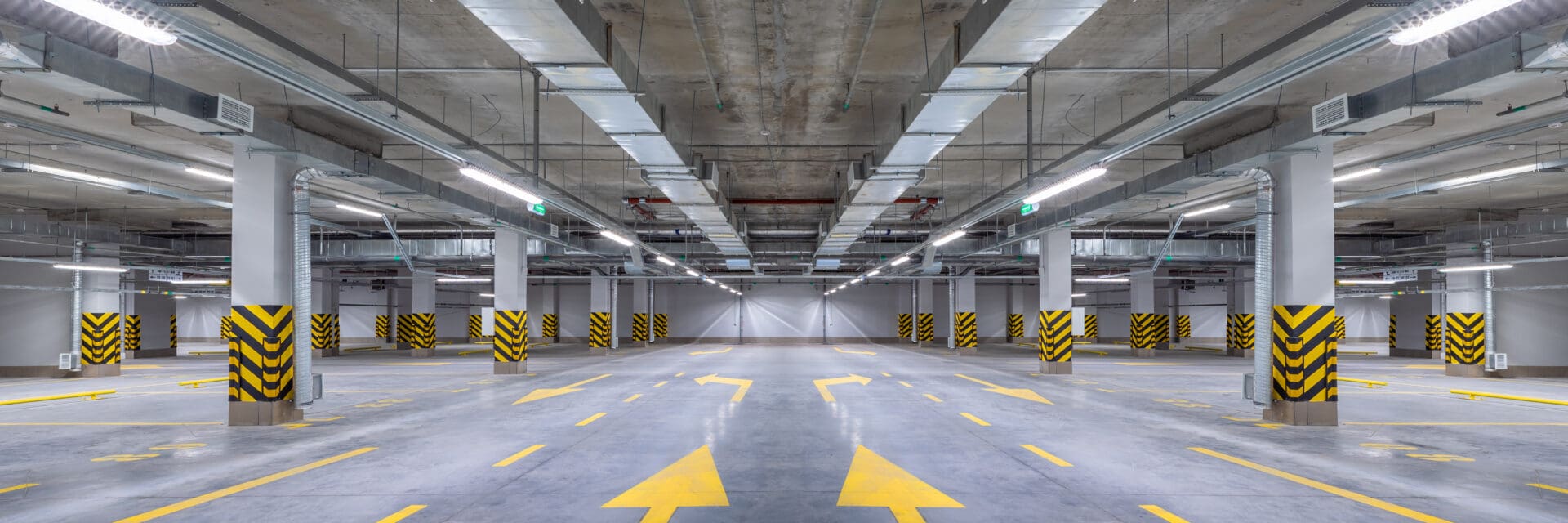 A parking garage with arrows pointing in different directions.