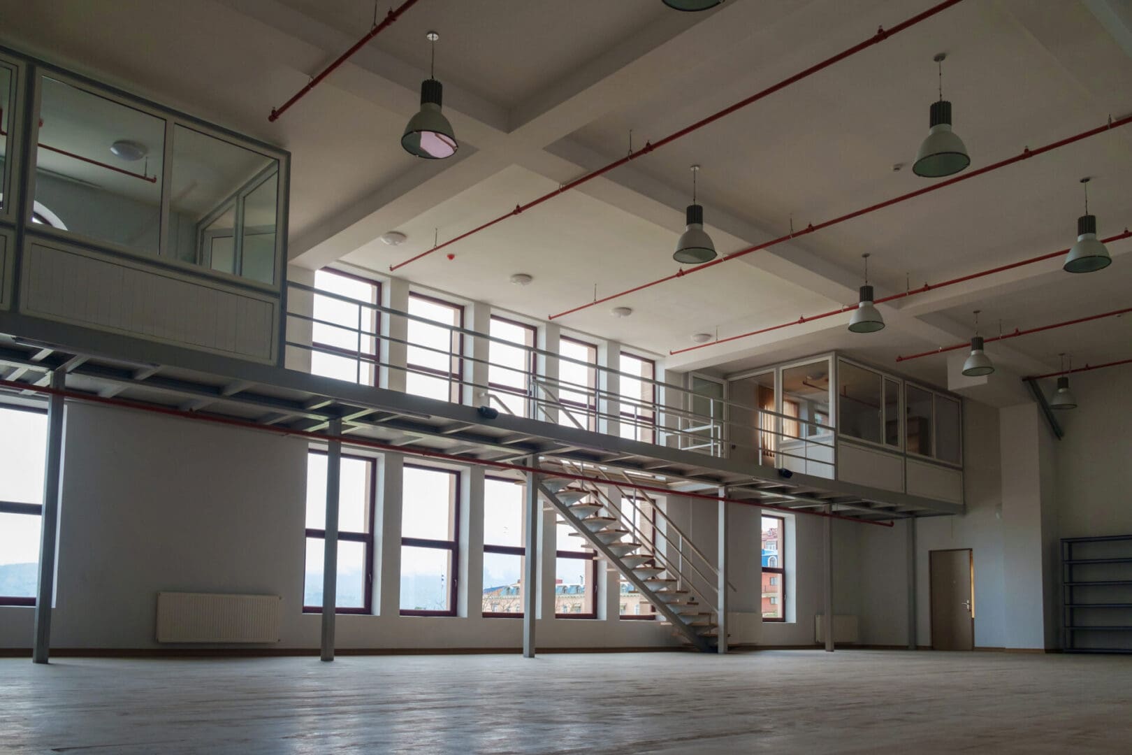 A large room with stairs and windows in it