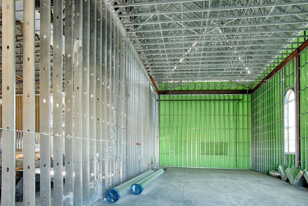A room with green walls and a metal ceiling.