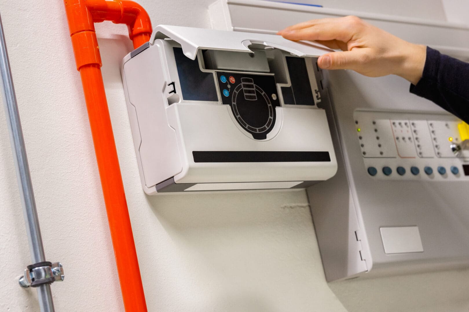 A person is putting money in an electronic machine.