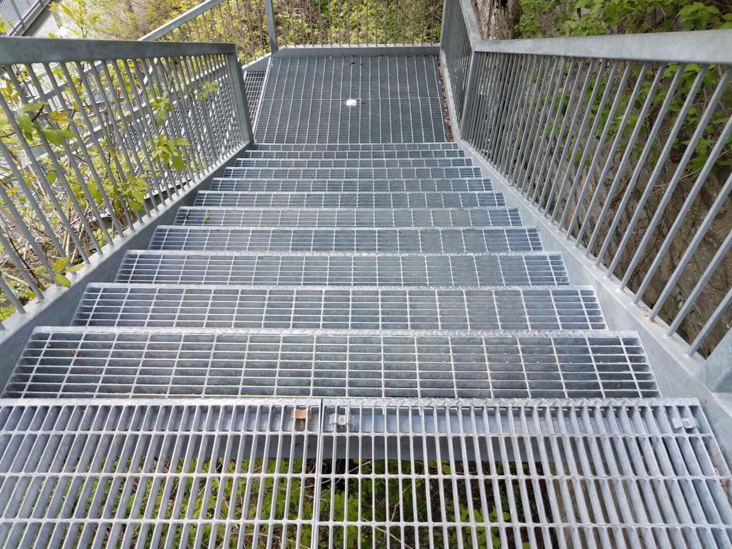 A metal walkway with steps going up to the top.