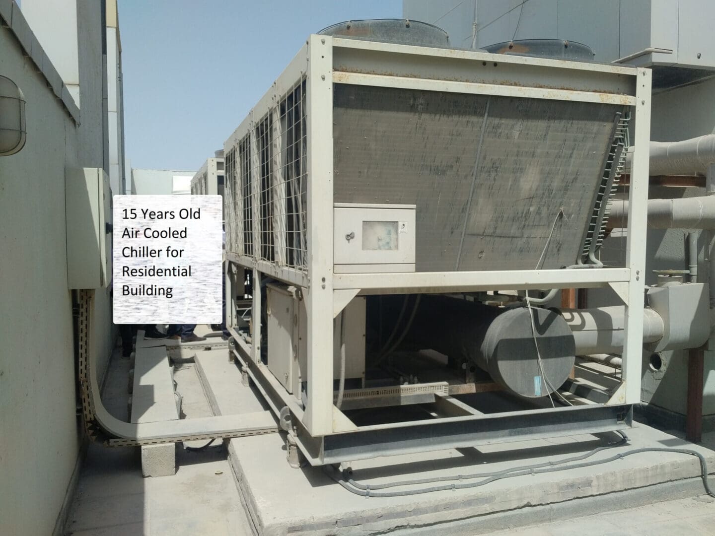 A large air conditioner unit sitting on top of concrete.