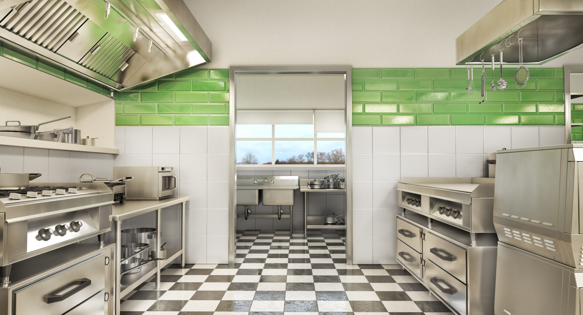 A kitchen with green and white tiles on the walls.