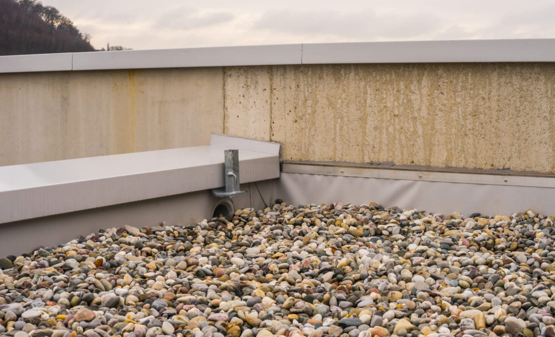 A pile of rocks on the ground near a building.