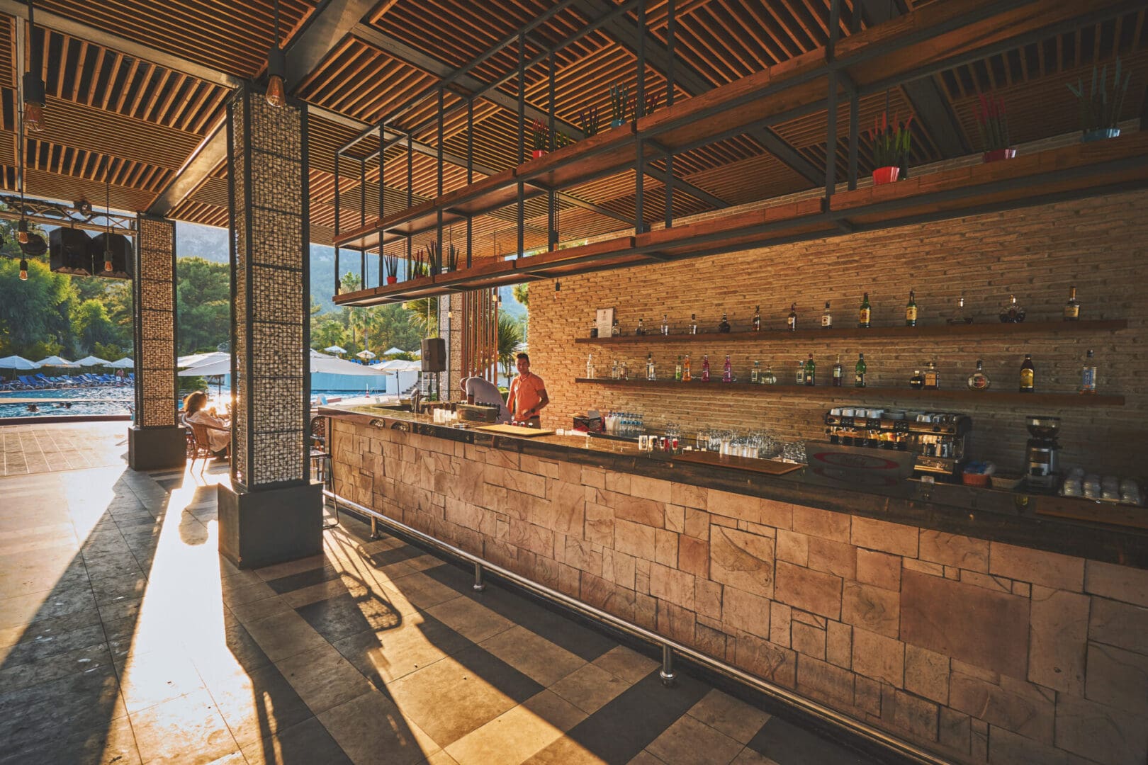 A restaurant with an open bar and several shelves.