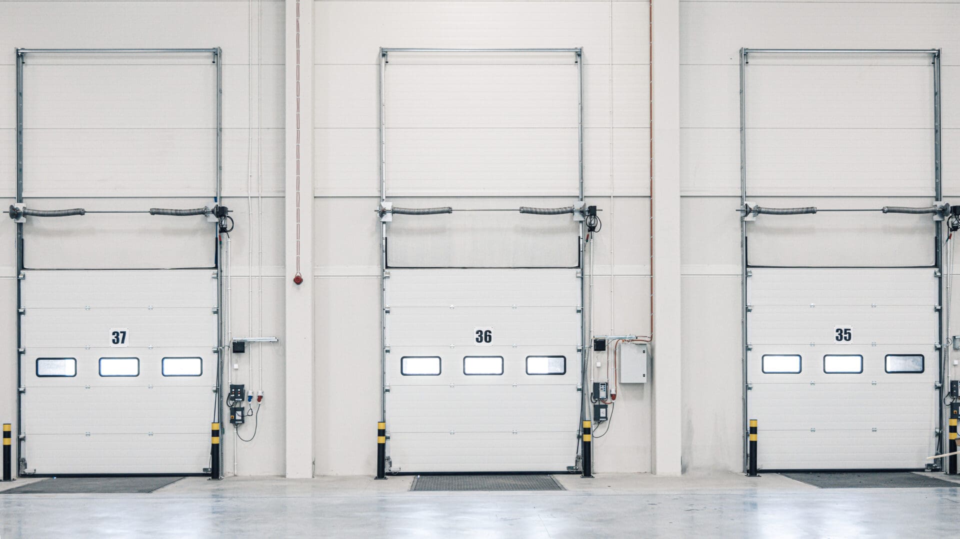 A white garage door with three large doors.