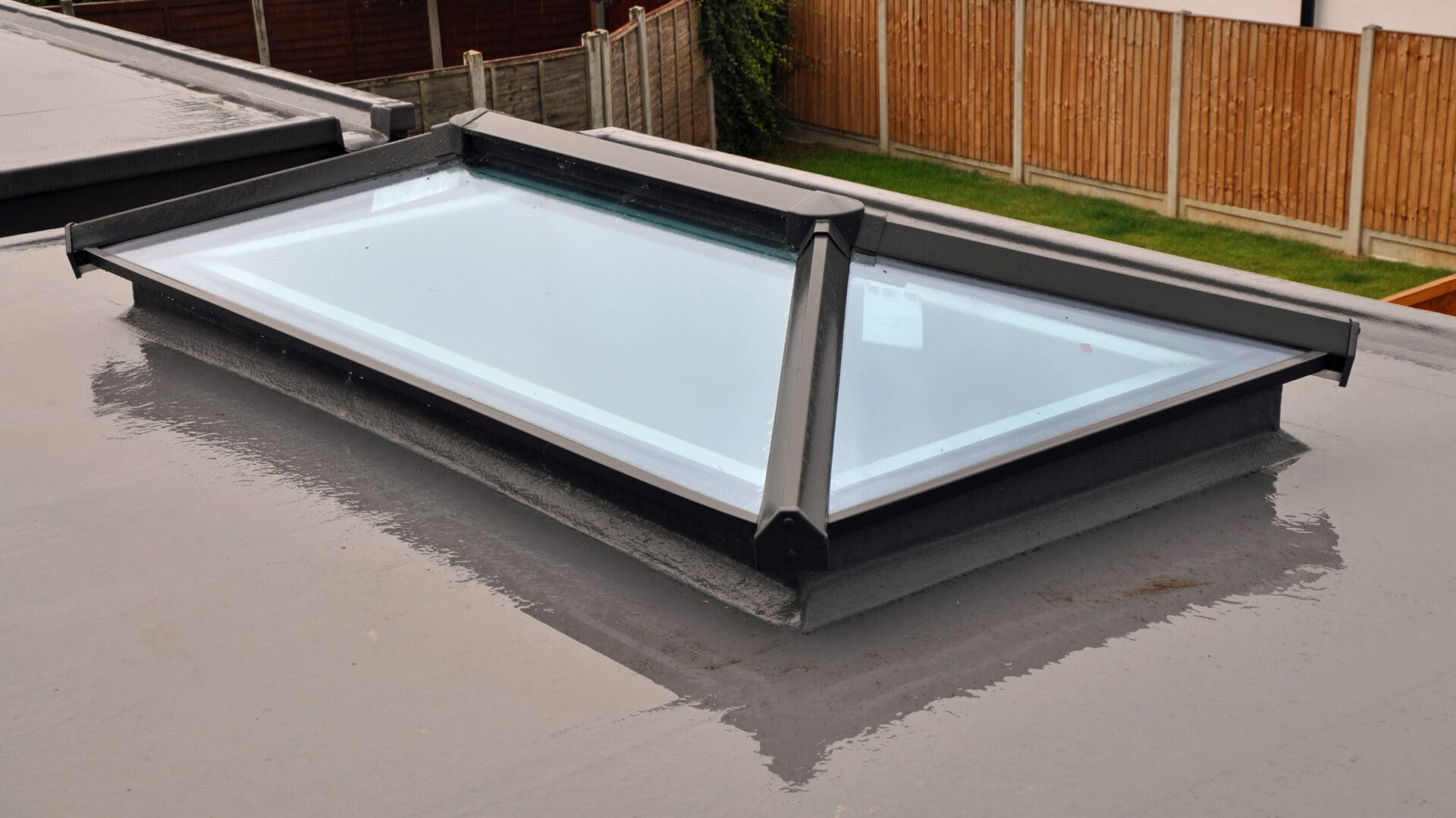 A large white skylight sitting on top of concrete.