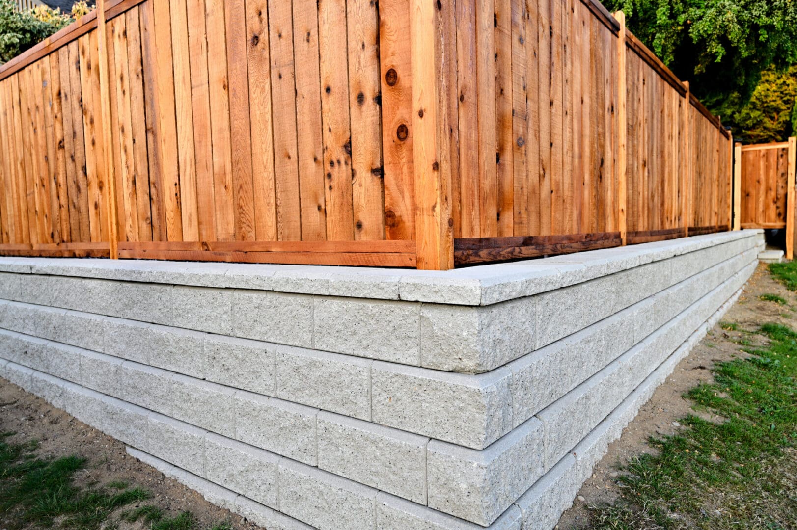 A wooden fence sitting next to a brick wall.