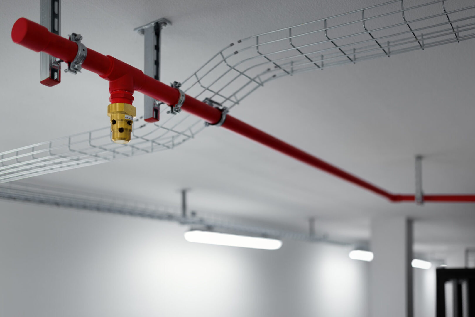 A red pipe hanging from the ceiling of a room.