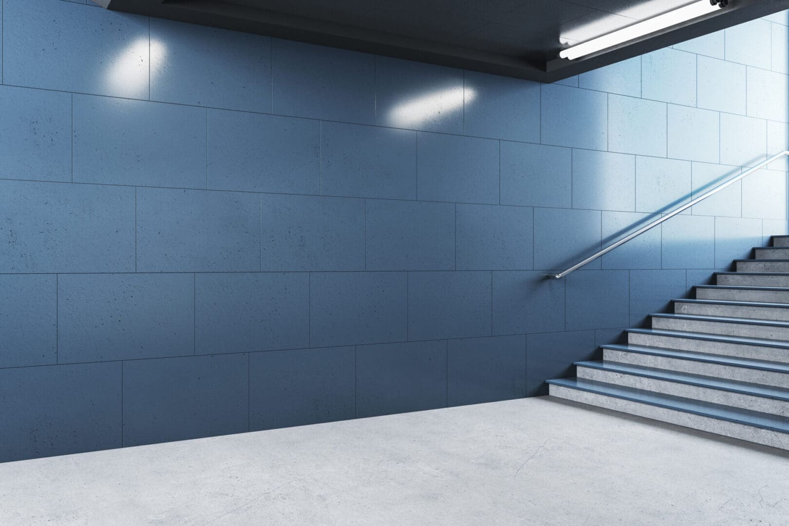 A blue wall with stairs leading to the top of it.