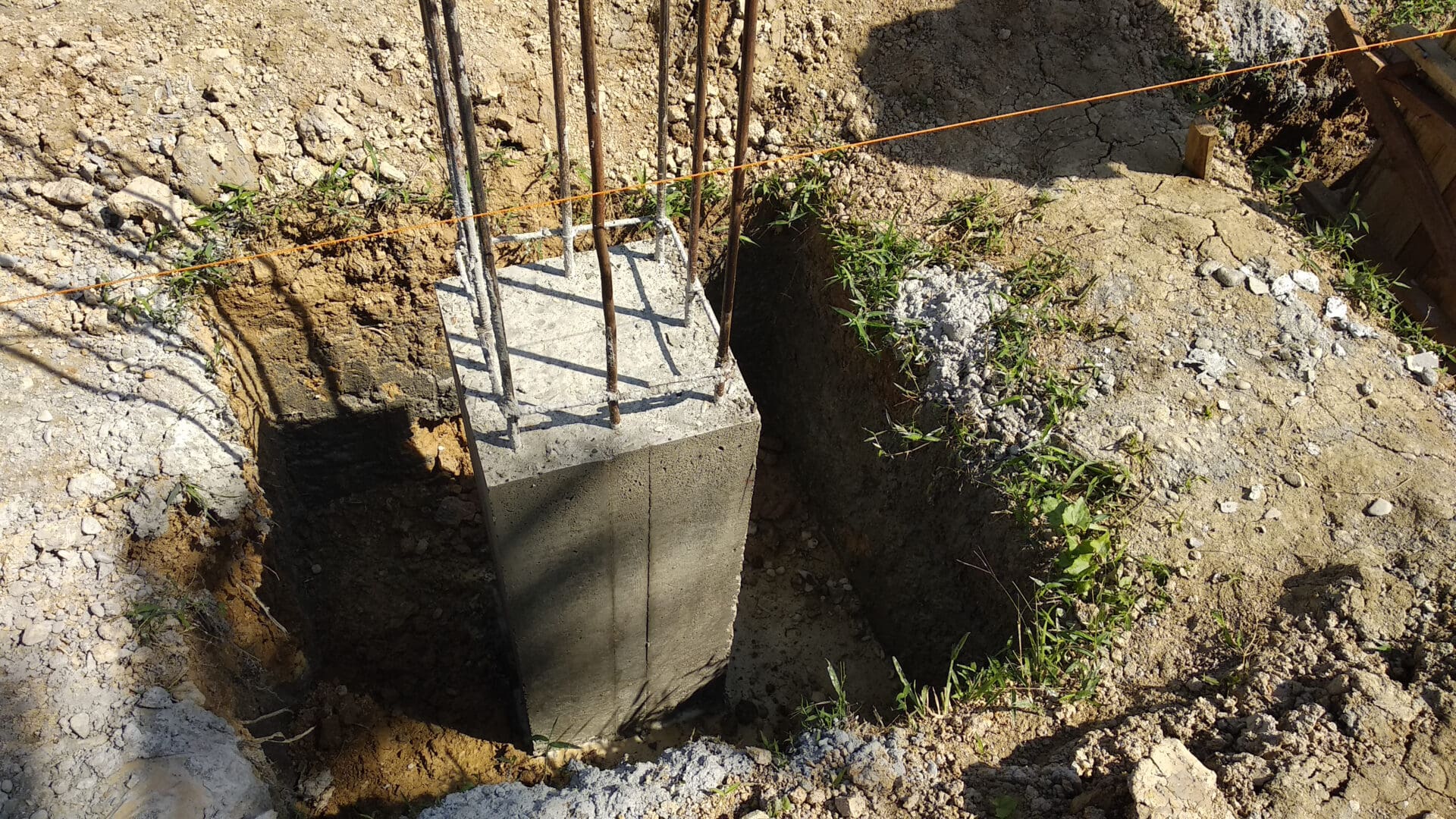 A concrete block with metal rods sticking out of it.