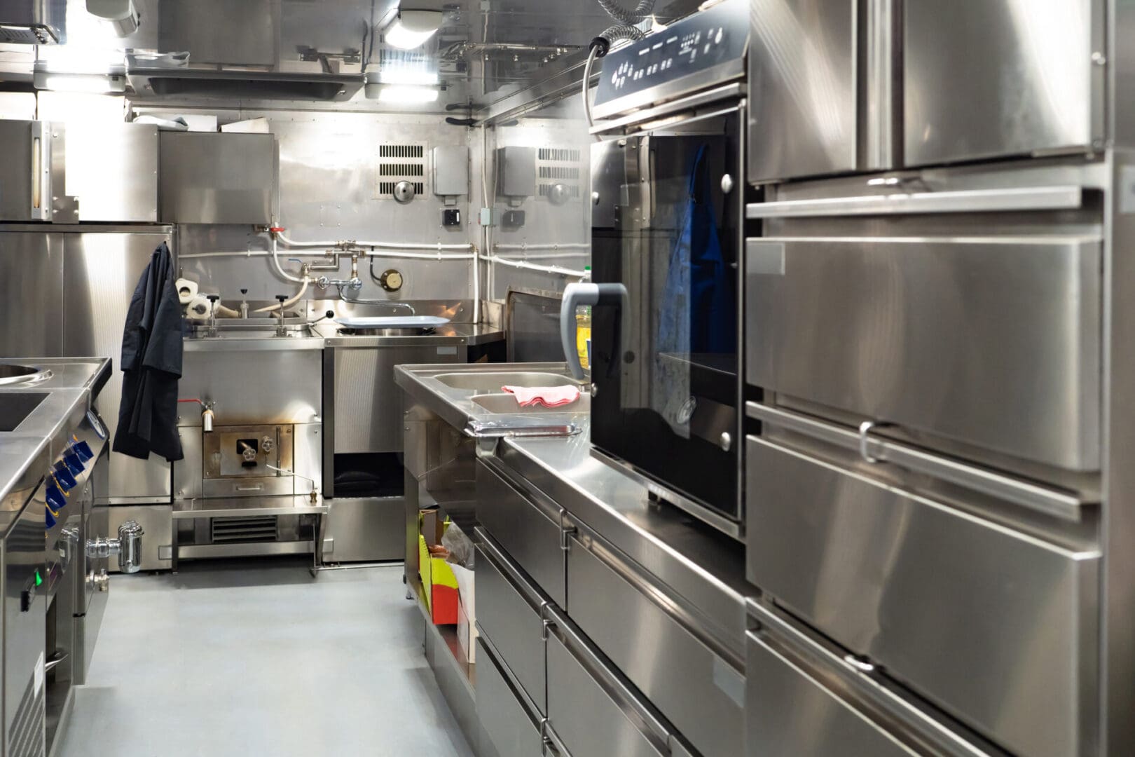 A kitchen with stainless steel appliances and counters.