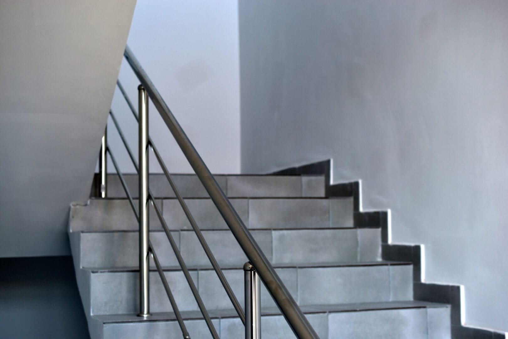 A staircase with metal railing and steps.