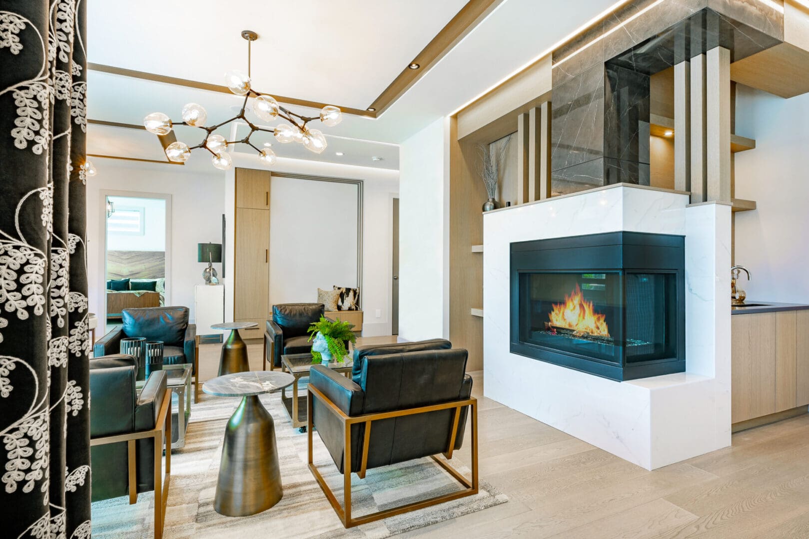 A living room with a fireplace and chairs