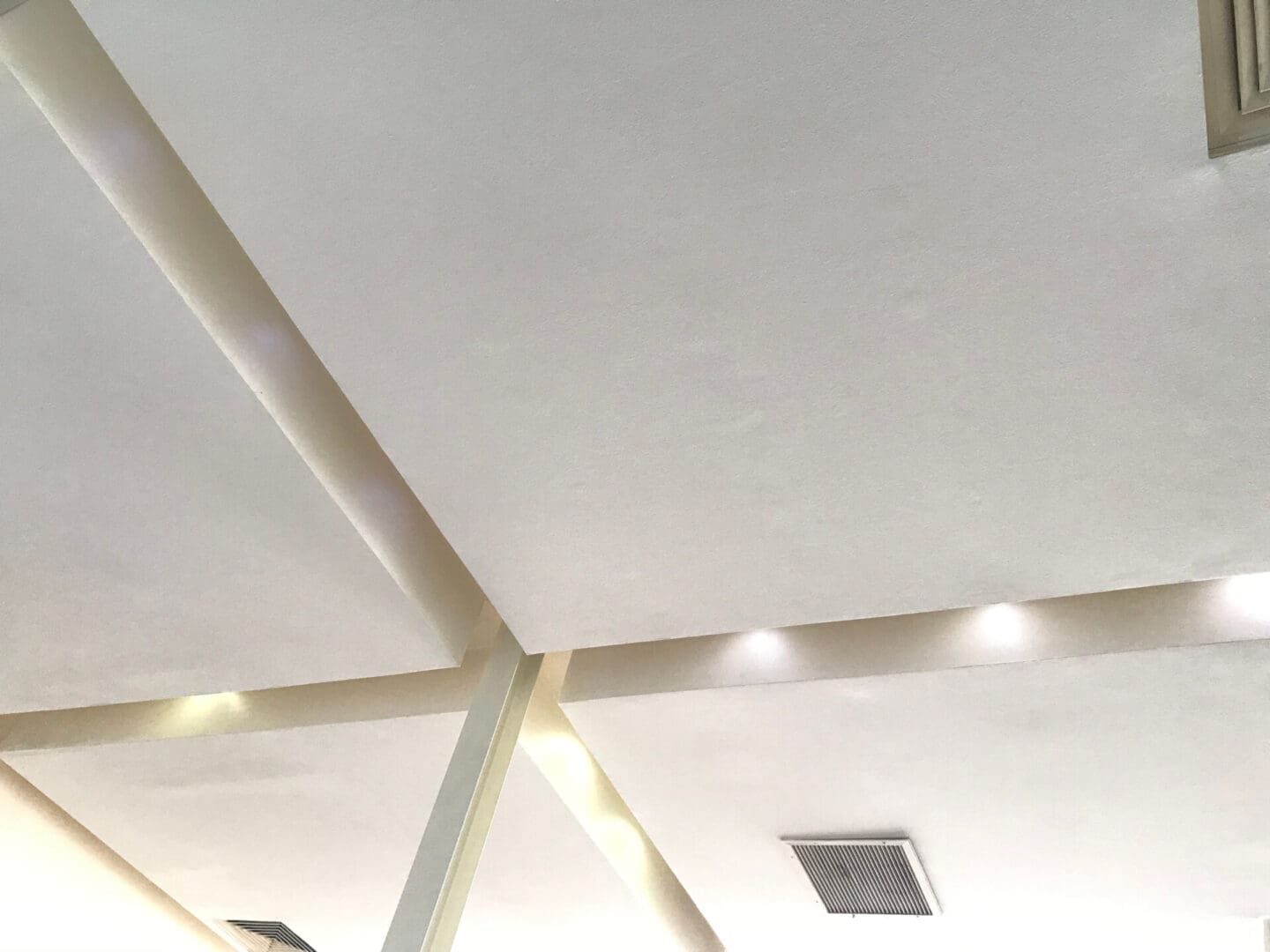 A ceiling with lights and a white wall